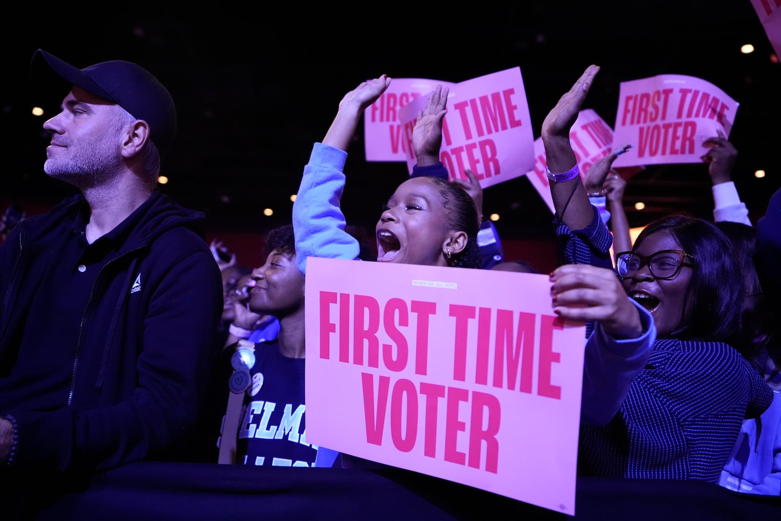 A first-time voter cheers before former first lady Michelle Obama speaks at a When We All Vote rally, Tuesday, Oct. 29, 2024, in College Park, Ga. (AP Photo/Brynn Anderson)