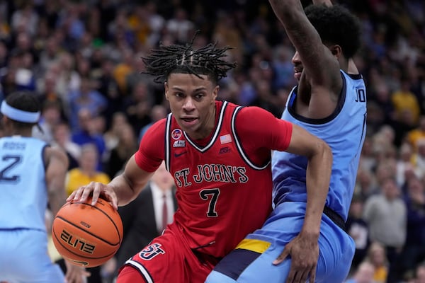 St. John's's Simeon Wilcher tries to get around Marquette's Kam Jones during the second half of an NCAA college basketball game Saturday, March 8, 2025, in Milwaukee. (AP Photo/Morry Gash)