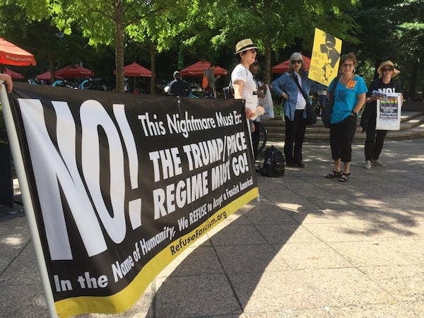 Protesters begin to gather in Woodruff Park in advance of President Donald Trump's visit to Atlanta on Wednesday afternoon. 