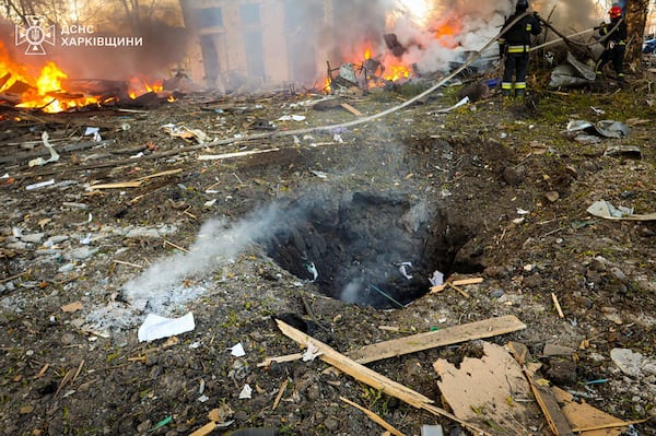 In this photo provided by the Ukrainian Emergency Service, firefighters put out the fire following a Russian rocket attack in Kharkiv, Ukraine, Friday, March 7, 2025. (Ukrainian Emergency Service via AP)