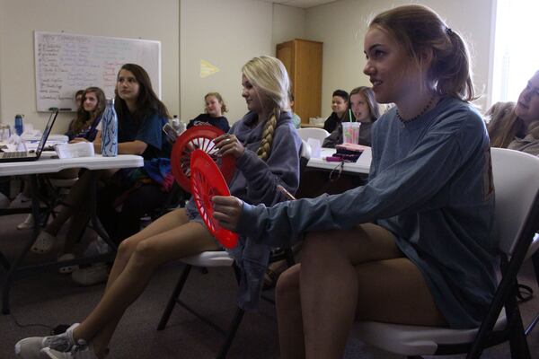 Kenley Speece, 15, and Peyton Lawrence, 15, right to left, participate in a texting and driving simulation with their classmates observing during a driver’s education class at Nathan’s Driving School, Inc. Georgia’s new distracted driving law will allow teens to use their phones for some purposes while driving - asl long as they use hands-free technology. Jenna Eason / Jenna.Eason@coxinc.com