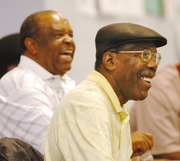 African-American golf legends Lee Elder, left, and Calvin Peete share a laugh as they talk with children at the East Lake Family YMCA in Atlanta during The Tour Championship at East Lake Golf Club in November 2005. (PHOTO BY CURTIS COMPTON/staff)