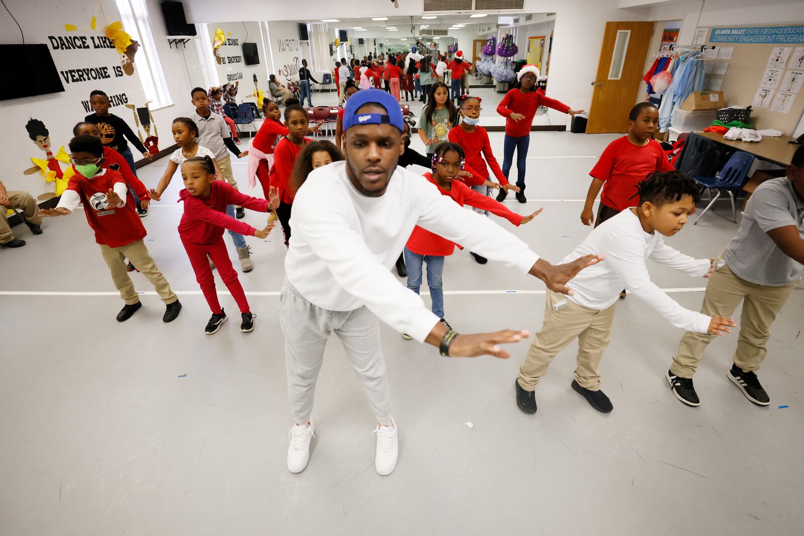 Dance teacher Cameron Davis helps second-grader students with some dance instructions on Tuesday, Dec. 13, 2022. Utopian Academy is partnering with Trilith Studios, the home of Marvel and D.C. blockbusters, in teaching young children about the world of film and TV.
 Miguel Martinez / miguel.martinezjimenez@ajc.com