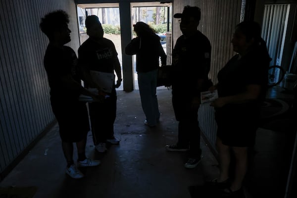 Canvassers with the Georgia Latino Alliance for Human Rights are seen on Saturday, March 1, 2025, leaving an apartment building in a Latino neighborhood where they shared information about how to interact with ICE agents in case they come to their doors. (Miguel Martinez/ AJC)