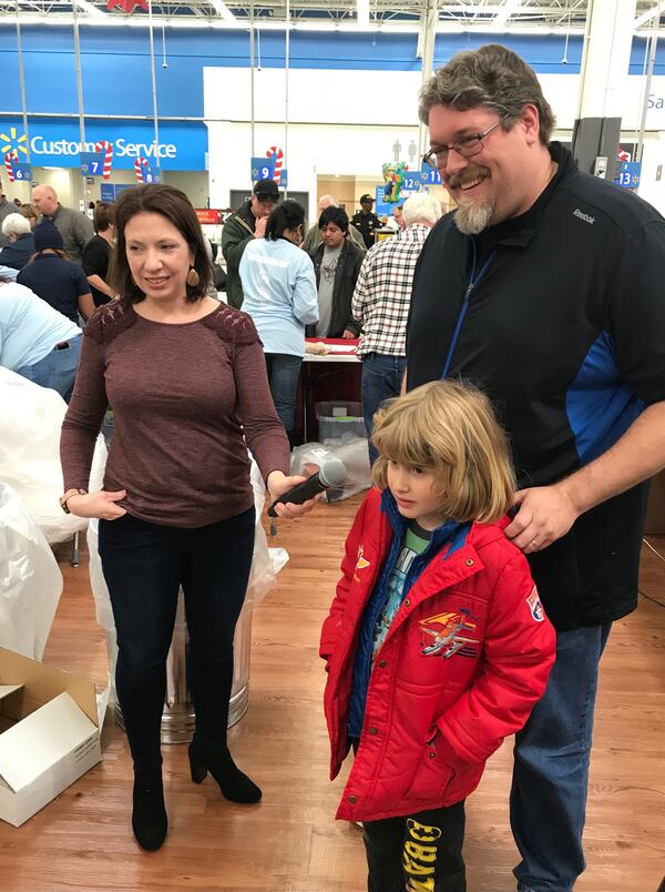  Davis Shaw and his six-year-old son Kellon talk to Clark Howard live on the radio. Producer Christa DiBiase (left) has worked with Clark for 20 years. CREDIT: Rodney Ho/rho@ajc.com