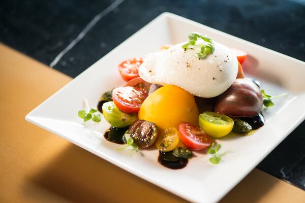 Heirloom Tomatoes and Burrata Salad with aged balsamic reduction and pesto. Photo credit- Mia Yakel.