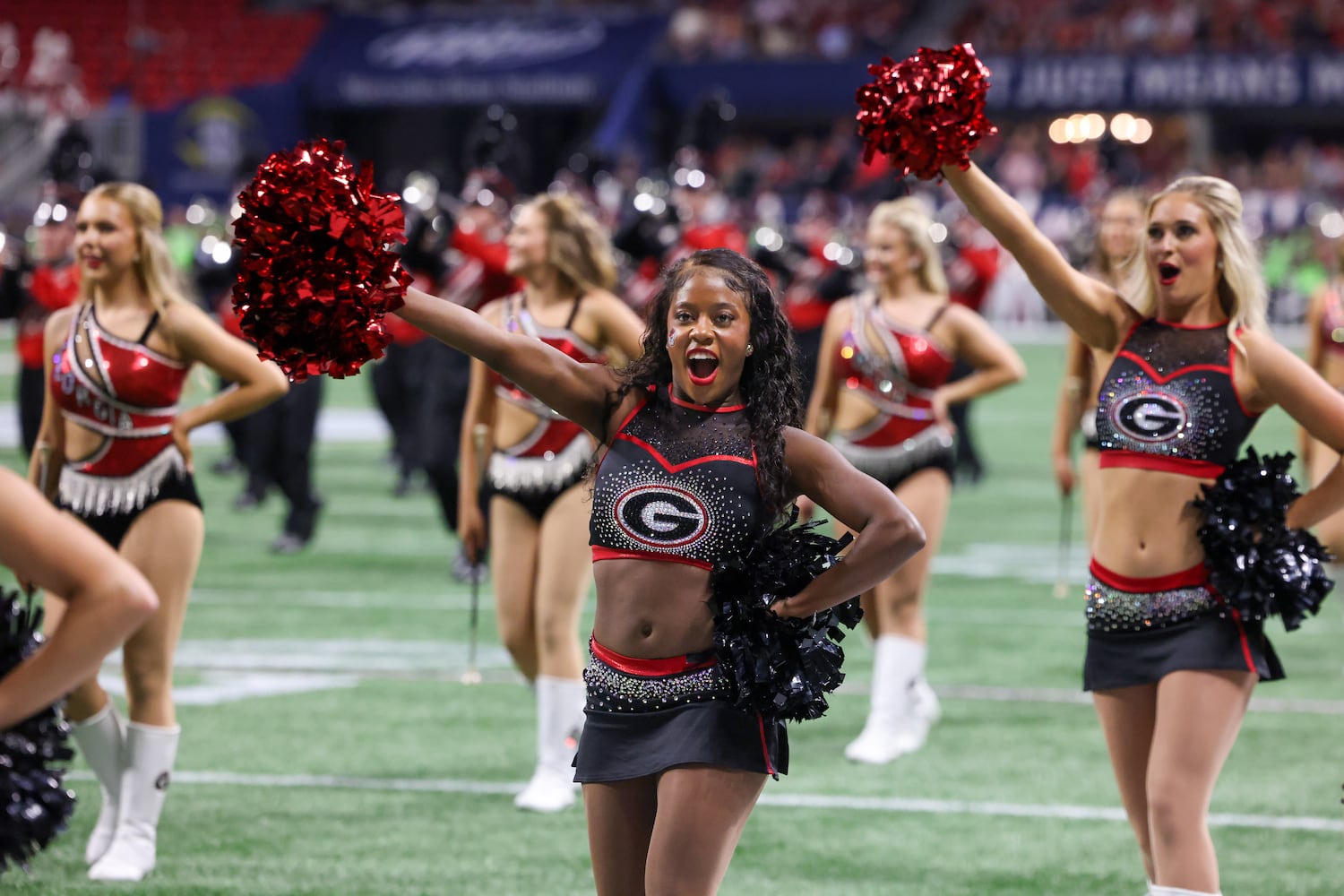 Georgia Bulldogs spirit team members perform against the Alabama Crimson Tide during the first half of the SEC Championship football game at the Mercedes-Benz Stadium in Atlanta, on Saturday, December 2, 2023. (Jason Getz / Jason.Getz@ajc.com)