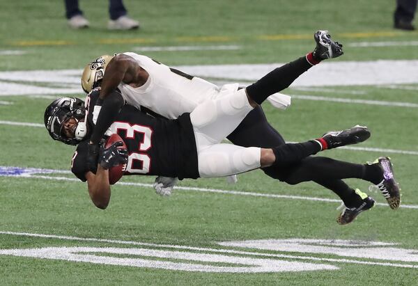 Falcons wide receiver Russell Gage is leveled by Saints safety Malcom Jenkins while catching a pass during the first half Sunday, Dec. 6, 2020, at Mercedes-Benz Stadium in Atlanta. (Curtis Compton / Curtis.Compton@ajc.com)