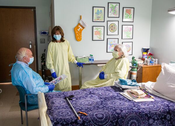 Social service director Sandi Thurber (center) chats with Tom Pendergrass as he visits with his friend and resident Cledith Perrigan at Northside Gwinnett Extended Care Center in Lawrenceville. (Phil Skinner for The Atlanta Journal-Constitution)