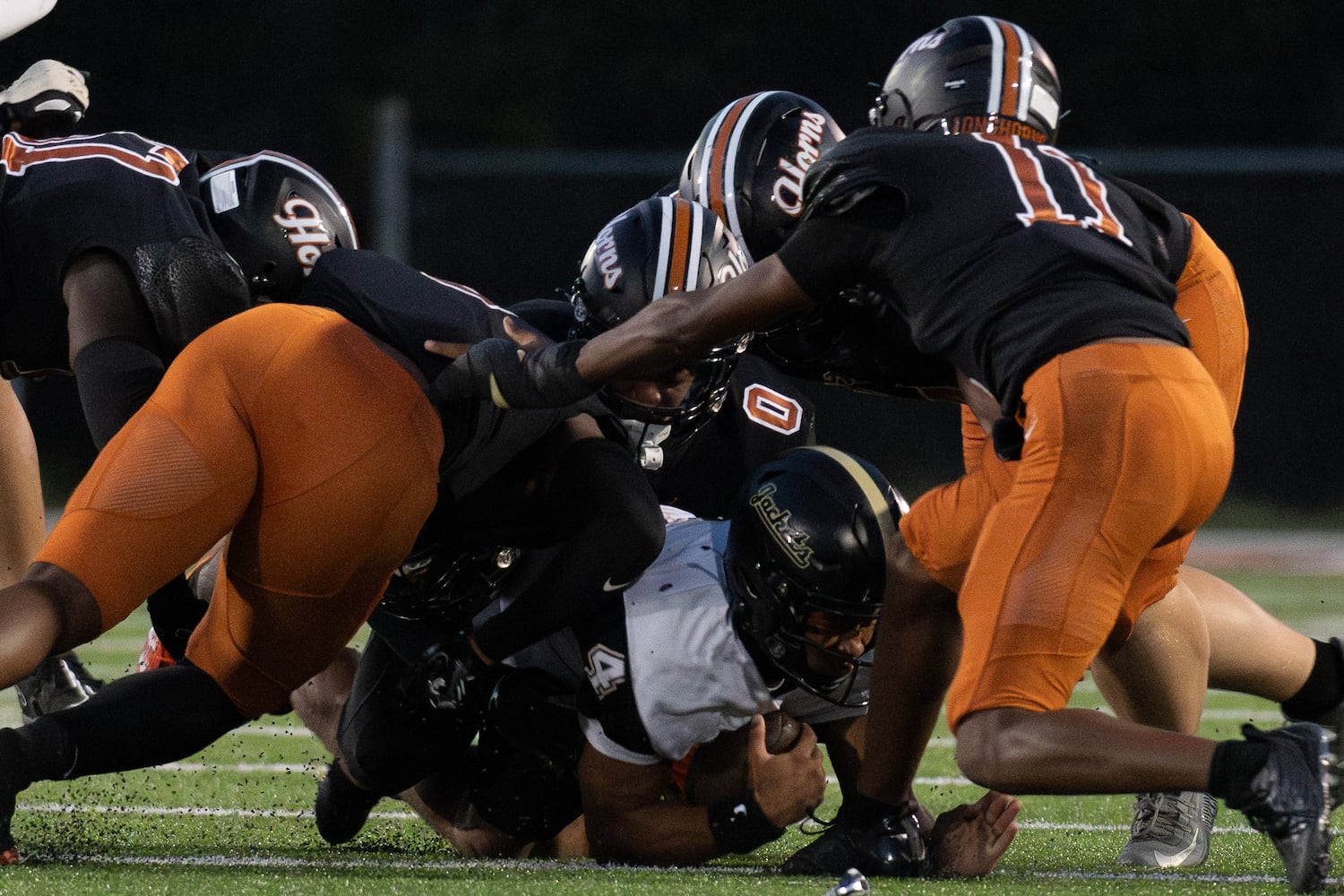 Sprayberry quarterback Jaden Duckett is sacked by several Kell defenders during Friday's game. (Jamie Spaar for the Atlanta Journal Constitution)