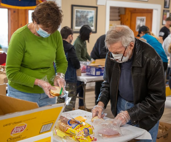 Carol Reeder (left) and Doug Huber make sandwiches along with a group of American Legion Post 140 Buckhead members and their family for USO Operation: Holiday Block Leave.  PHIL SKINNER FOR THE ATLANTA JOURNAL-CONSTITUTION.