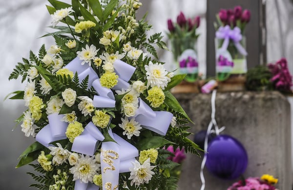 January 22, 2021 Cobb County: Flowers were laid side by side along the school sign in front of Kemp Elementary School at 865 Corner Road in Powder Springs on Monday, Jan. 25, 2021 where Dana Johnson, a first-grade teacher who worked at Kemp Elementary School, died last Thursday morning, six weeks after she was admitted to the hospital with COVID-19, said Principal Billy Pritz. (John Spink / John.Spink@ajc.com)

