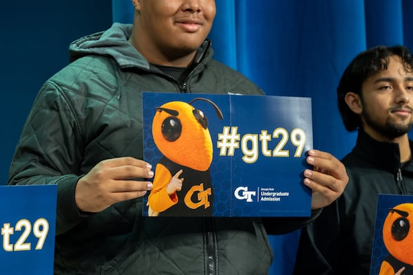 Students hold Georgia Tech placards after finding out they were admitted early to Georgia Tech at a ceremony at Benjamin E. Mays High School in Atlanta on Friday, December 6, 2024. (Arvin Temkar / AJC)