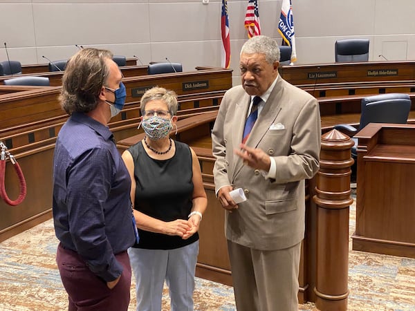 Former Atlanta City Council president Cathy Woolard, center, stands between Fulton County Chair Robb Pitts, right, and Fulton elections head Richard Barron, left, at her swearing-in ceremony Wednesday, Sept. 29, 2021 as new chair of Fulton County’s board of registration and elections. (Ben Brasch/AJC)