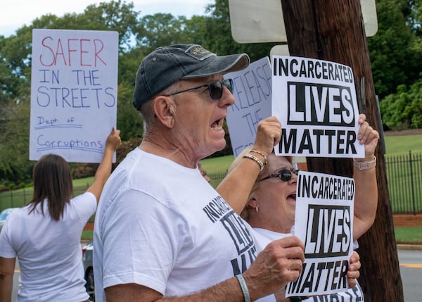 Incarcerated Lives Matter protesters, including Roger Bolish, call for reform of the Georgia prison system with a gathering across the street from the Governor's Mansion in Buckhead on Tuesday. That day, the U.S. Department of Justice released a report on Georgia's state prisons that found them "inhumane" and violent. (Jenni Girtman for The Atlanta Journal-Constitution)