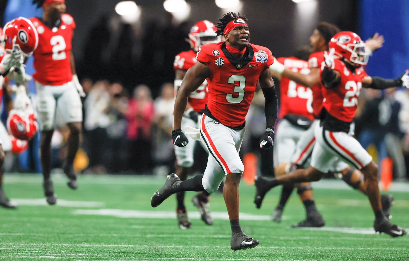 Georgia players react after Ohio State missed a field game to give Georgia the win at the end of the College Football Playoff Semifinal between the Georgia Bulldogs and the Ohio State Buckeyes at the Chick-fil-A Peach Bowl In Atlanta on Saturday, Dec. 31, 2022.  Georgia won, 42-41. (Jason Getz / Jason.Getz@ajc.com)