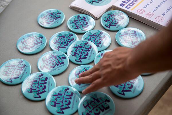 08/27/2021 — Atlanta, Georgia — My Muslim Voter pins are displayed at the Georgia Muslim Voter Project table outside of the Al-Farooq Masjid in downtown Atlanta, Friday, August 27, 2021. (Alyssa Pointer/Atlanta Journal Constitution)