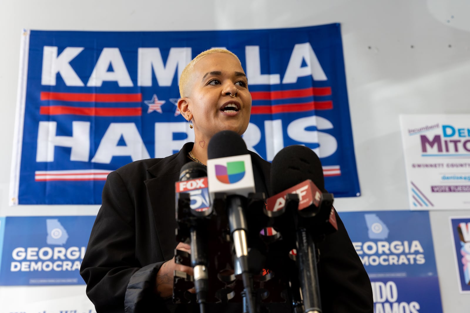 Lisette Correa, CEO of Arrrtaddict, speaks at news conference at a Democratic campaign office in Norcross on Tuesday.