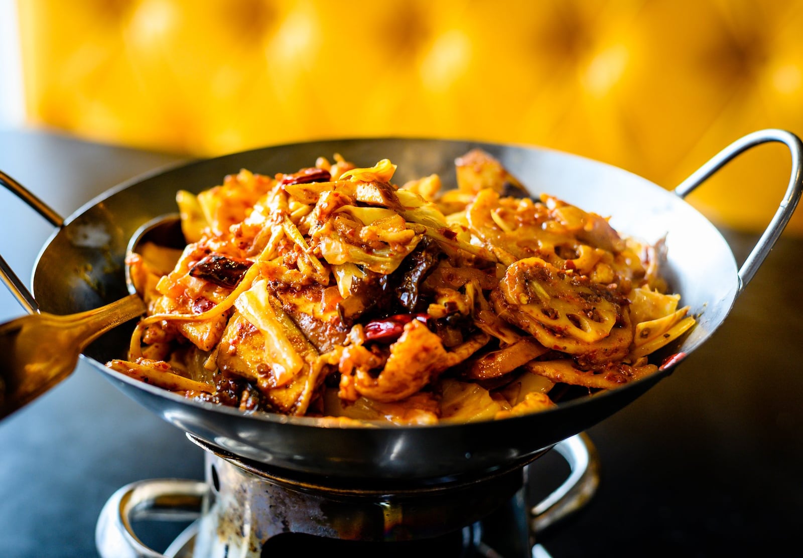 The spicy and numbing chicken hot pot at Urban Wu in a fiery orange chile oil. CONTRIBUTED BY HENRI HOLLIS