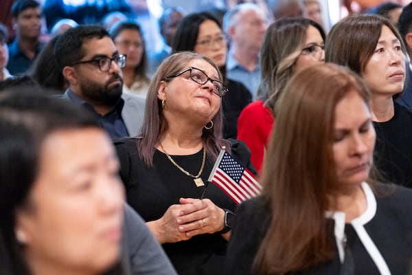 Dina Pimentel, from Argentina, can’t hold back her emotions after she was sworn in as a naturalized citizen during a ceremony at The Carter Center in Atlanta on Sunday, Oct. 1, 2023. The ceremony was held at the center in honor of President Jimmy Carter’s 99th birthday.   (Ben Gray / Ben@BenGray.com)