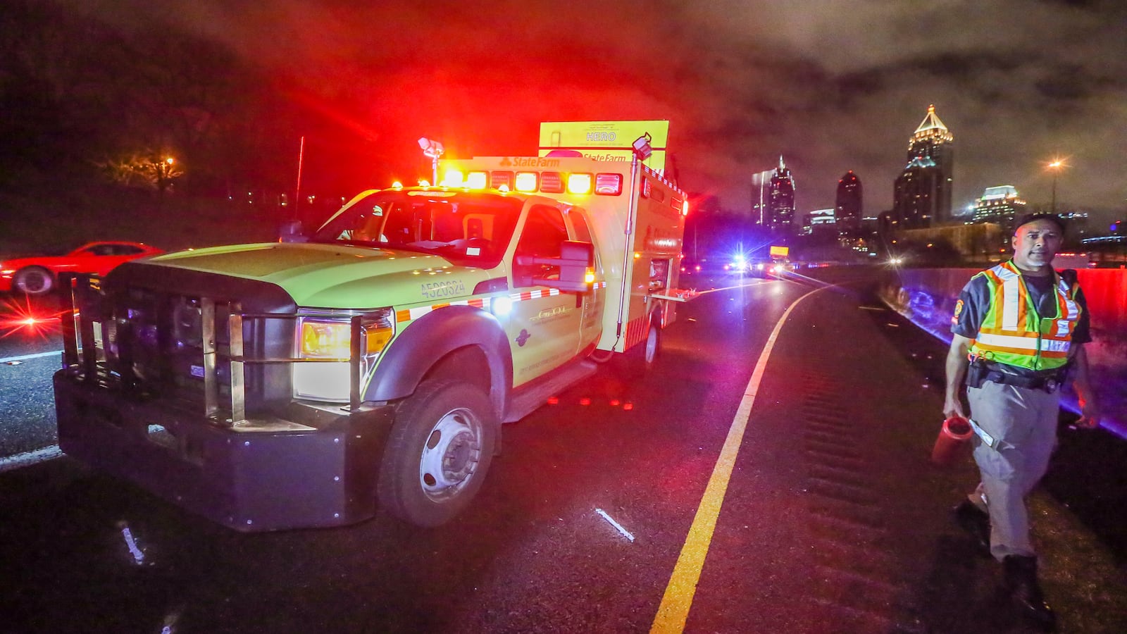 LEDE PHOTO - Dec. 24, 2015 Atlanta: GDOT HERO operator, Griff Singleton walks past the HERO truck where a Georgia Department of Transportation Highway Emergency Response Operator was hit by a pickup truck and injured while working a wreck in Midtown during Thursday's predawn storms Dec. 24, 2015. The incident happened about 4:45 a.m. on the northbound I-75 HOV ramp at the Brookwood Interchange. According to the Georgia State Patrol, HERO driver Christopher D. Seslar was putting out flares to block the roadway after an earlier wreck when he was hit by a 1998 Ford pickup truck. The pickup driver, Richard K. Hutto, 38, of Fitzgerald, apparently struck a guard rail first, then over-corrected and hit Seslar, a GSP spokesperson said in an email. Hutto, who was not injured, was charged with reckless driving, failure to maintain lane, driving too fast for conditions, driving on a suspended license, failure to exercise due care and to obey the state's "move over" law that requires drivers to move over a lane when approaching an emergency vehicle. Channel 2 Action News reported that Seslar was taken to Grady Memorial Hospital in stable condition. JOHN SPINK /JSPINK@AJC.COM