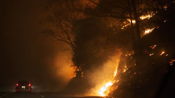 Fire erupts on the side of The Spur on Highway 441 between Gatlinburg and Pigeon Forge, Tenn., Monday, Nov. 28, 2016.