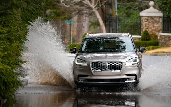 Several roads had standing water on Sunday after the storms, including Harris Trail in northwest Atlanta. Sunday, February 16, 2025 (Ben Hendren for the Atlanta Journal-Constitution)