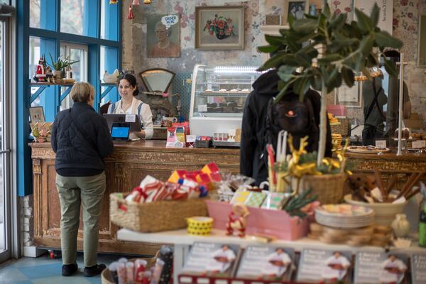 Back in the Day Bakery employee Sophia Fallanca checks out a customer at the shop in the Starland District. Stephen B. Morton for The Atlanta Journal-Constitution