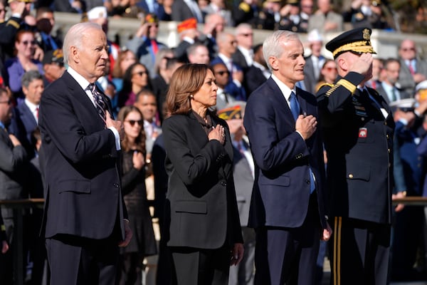 President Joe Biden, from left, Vice President Kamala Harris, Veterans Affairs Secretary Denis McDonough and Maj. Gen. Trevor Bredenkamp, commanding general of the Joint Task Force-National Capital Region and the U.S. Military District of Washington, stand during a wreath laying ceremony at the Tomb of the Unknown Soldier on National Veterans Day Observance at Arlington National Cemetery in Arlington, Va., Monday, Nov. 11, 2024. (AP Photo/Mark Schiefelbein)