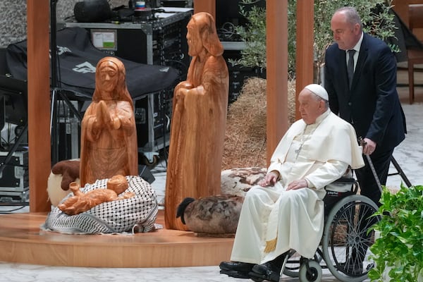 Pope Francis arrives to meet the donors of the fir tree set up in St. Peter's Square as a Christmas tree and those who have crafted the life-size nativity scene at the tree's feet, in the Paul VI hall at the Vatican, Saturday, Dec. 7, 2024. (AP Photo/Andrew Medichini)