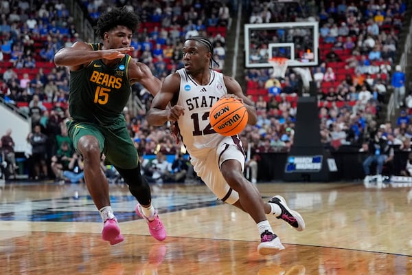 Mississippi State guard Josh Hubbard (12) drives toward the basket past Baylor forward Norchad Omier (15) during the first half in the first round of the NCAA college basketball tournament, Friday, March 21, 2025, in Raleigh, N.C. (AP Photo/Stephanie Scarbrough)