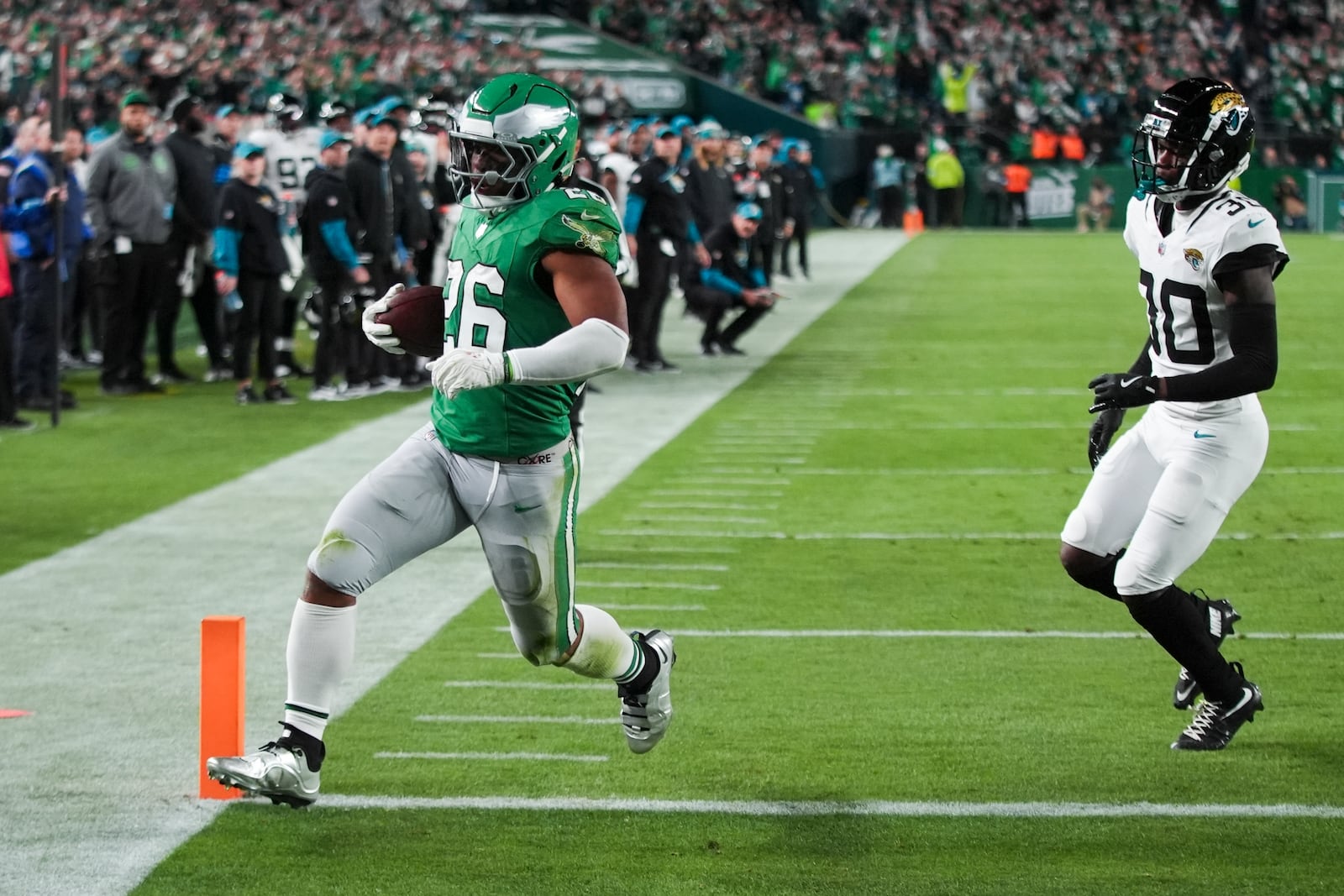 Philadelphia Eagles running back Saquon Barkley (26) scores a touchdown in front of Jacksonville Jaguars cornerback Montaric Brown (30) during the first half of an NFL football game Sunday, Nov. 3, 2024, in Philadelphia. (AP Photo/Chris Szagola)