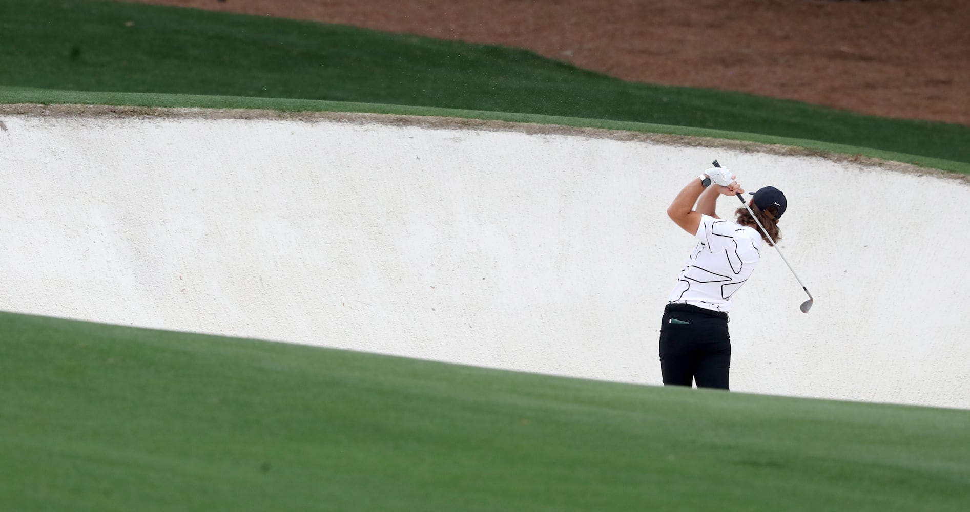 April 10, 2021, Augusta: Tommy Fleetwood hits out of the bunker on the eighth fairway during the third round of the Masters at Augusta National Golf Club on Saturday, April 10, 2021, in Augusta. Curtis Compton/ccompton@ajc.com