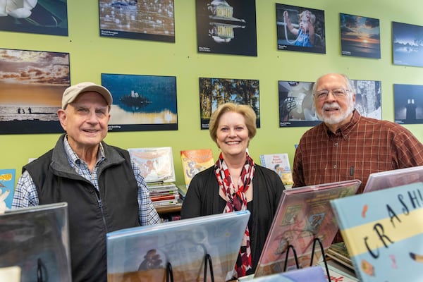 Peachtree Corners Photography Club members David Schilling (from left), Tracey Rice and Richard Phillips stand with some of their work on display at the Peachtree Corners Branch Library. PHIL SKINNER FOR THE ATLANTA JOURNAL-CONSTITUTION