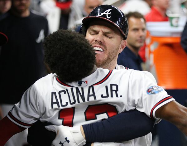 Freddie Freeman hugs Ronald Acuna in a 2018 game.   Curtis Compton/ccompton@ajc.com