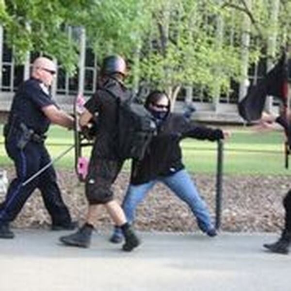 Protesters clashed with police at Auburn University Tuesday after a white nationalist Richard Spencer won a court battle to speak on campus. University police said they arrested three demonstrators.