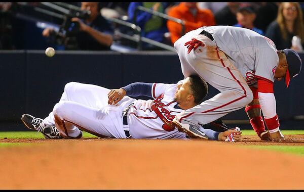 Andrelton Simmons was safe and Nationals third baseman Yunel Escobar had a cut left hand after this slide by Simmons that infuriated Washington players during Monday's 8-4 Atlanta win. (Curtis Compton/AJC)