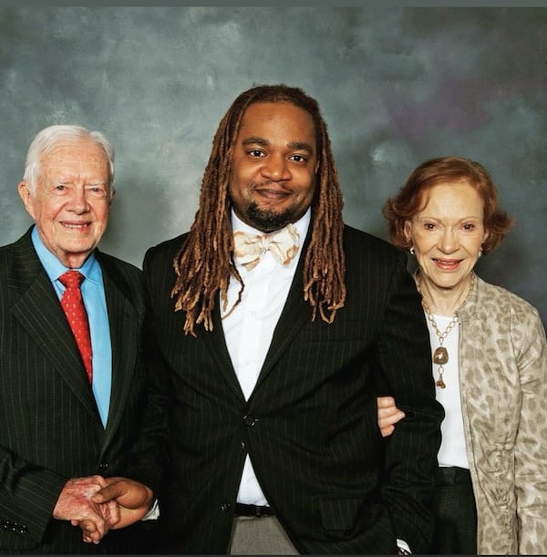 Mashaun D. Simon (center), with former President Jimmy Carter and Rosalynn Carter.