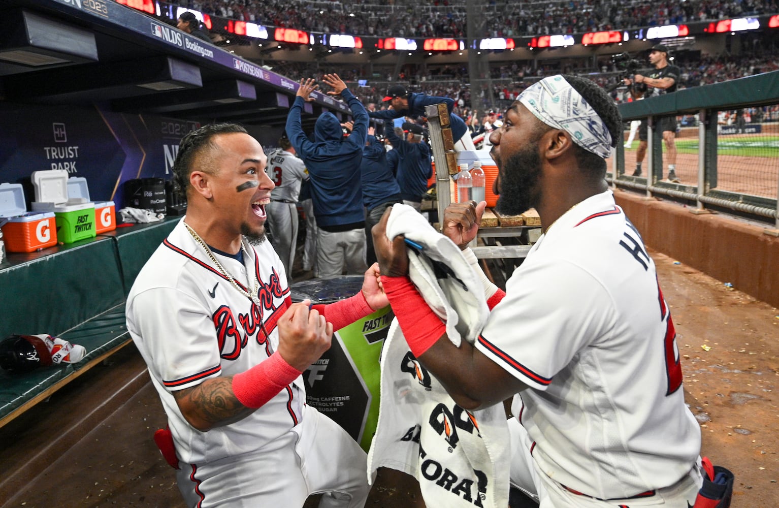 Atlanta Braves’ Orlando Arcia (11) and Michael Harris II (23) celebrate after Austin Riley’s two-run home run against the Philadelphia Phillies during the eighth inning of NLDS Game 2 in Atlanta on Monday, Oct. 9, 2023.   (Hyosub Shin / Hyosub.Shin@ajc.com)