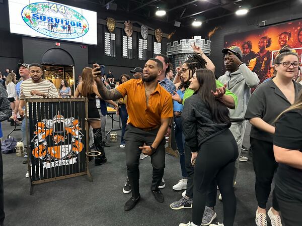 Brandon Cottom, a "Survivor 44" contestant, does a selfie at Ron Clark's "Survivor" party April 12, 2023 at Ron Clark Academy. RODNEY HO/rho@ajc.com