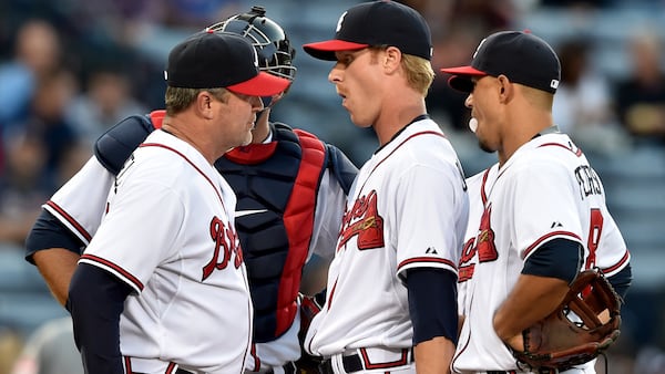 Mike Foltynewiez (center) in his Braves debut and first major league appearance as a starter in 2015, gets a visit from then pitching coach Roger McDowell in the first inning.