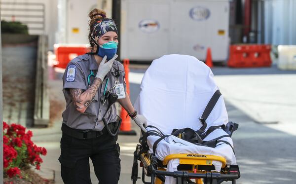 Grady Advanced EMT, Emma Hovis prepares for another patient call on Monday, March 30, 2020. First responders at Grady Hospital are on the frontline of the COVID-19 epidemic taking precautions on each call. Grady was already recovering from a broken water pipe that closed three floors of its trauma center and put a strain on the hospital’s occupancy when COVID-19 began to infect Georgians. (JOHN SPINK/JSPINK@AJC.COM)