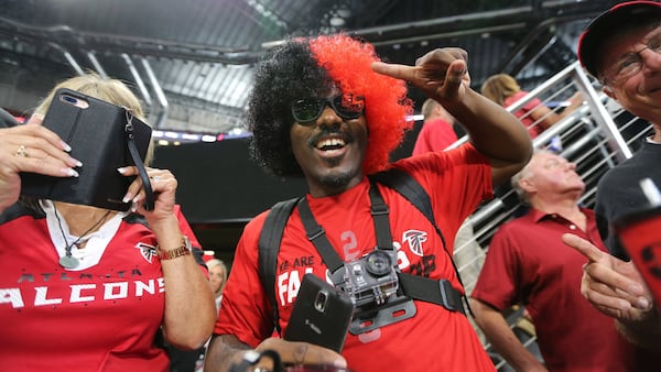 Fans use various record devices as the first Atlanta Falcons game at Mercedes-Benz Stadium gets under way Saturday, Aug. 26, 2017, in Atlanta. The Falcons faced the Arizona Cardinals in an exhibition game.