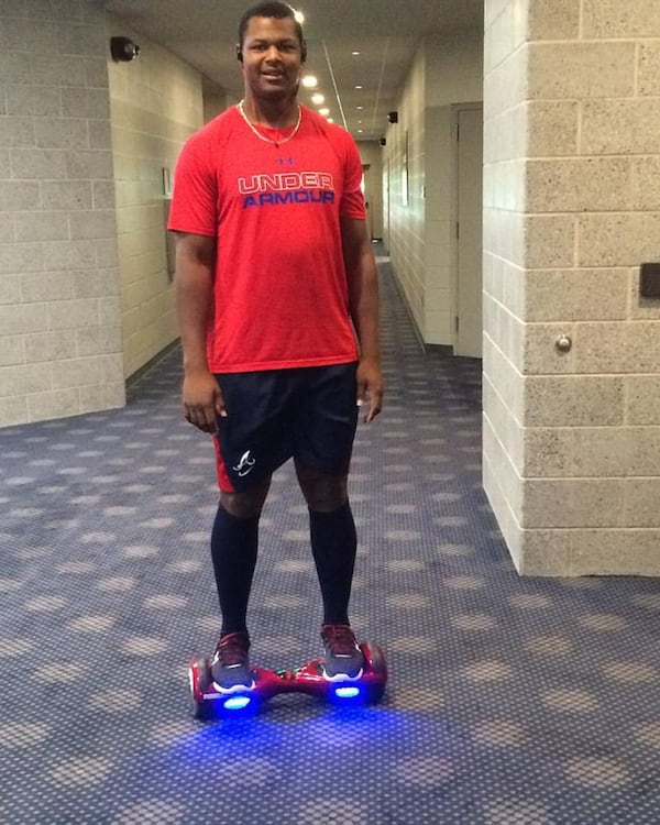 Mauricio Cabrera on the self-balancing scooter unicycle he rides to the ballpark from his nearby hotel at the Arizona Fall League. (Photo by David O'Brien)