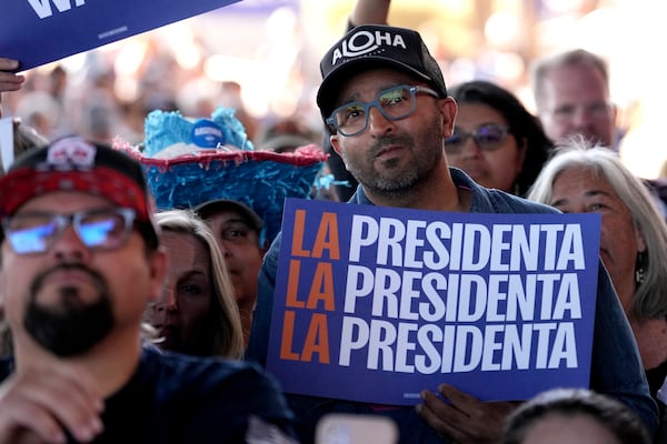 FILE - A supporter holds a sign as Democratic presidential nominee Vice President Kamala Harris speaks during a campaign event, Oct. 31, 2024, in Phoenix. (AP Photo/Ross D. Franklin, File)