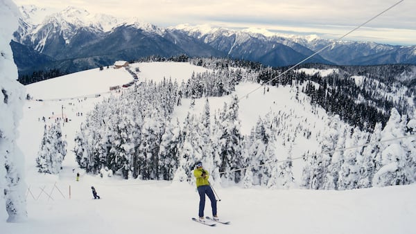 A skier nears the top of the rope tow at Hurricane Ridge in Olympic National Park. The visitor center is in the background. (Caitlin Moran/The Seattle Times/TNS)