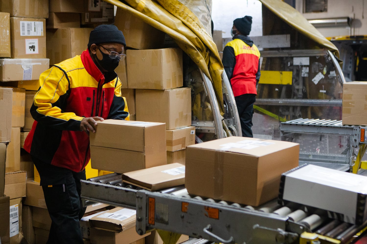 Willie Gurerra sorts packages on Wednesday, December 16, 2020, at DHL Express in Atlanta. Workers at the shipping center worked to fulfill orders during the holiday rush. CHRISTINA MATACOTTA FOR THE ATLANTA JOURNAL-CONSTITUTION.