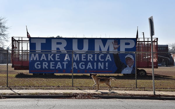 The 30-foot Trump banner visible on US 280 cost Rex Bullock about $700 to print, and soon attracted young selfie-takers. Bullock later put up a 40-foot banner that he says got a lot of attention from motorists as it was unveiled. Bullock says that the signs gave an image to people's frustrations. HYOSUB SHIN / HSHIN@AJC.COM