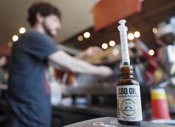 Jason Hoover, barista, prepares espresso drinks at Rev Coffee in Smyrna, which offers a CBD oil latte as well as the option to add it to any beverage. Cannabidiol oil products are gaining in popularity. They use a syringe to measure 10 ml shots. Bob Andres / bandres@ajc.com