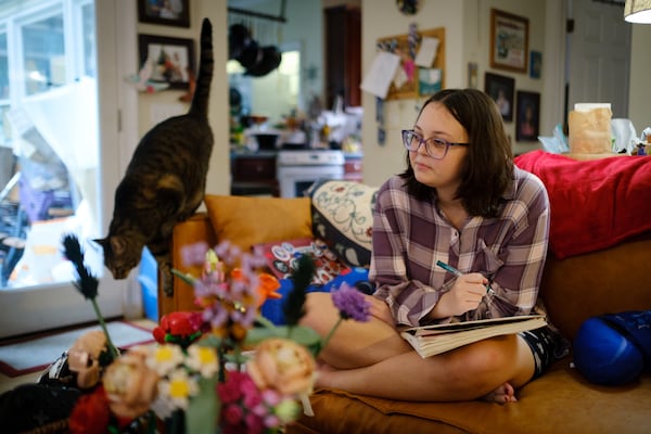 Latha Wright battles anxiety. When her family initially sought help, they encountered obstacles that make it difficult for many Georgia teens and young adults to get therapy and proper medication. Here she is seen doing homework at her home in Atlanta on Wednesday, May 25, 2022. (Arvin Temkar / arvin.temkar@ajc.com)